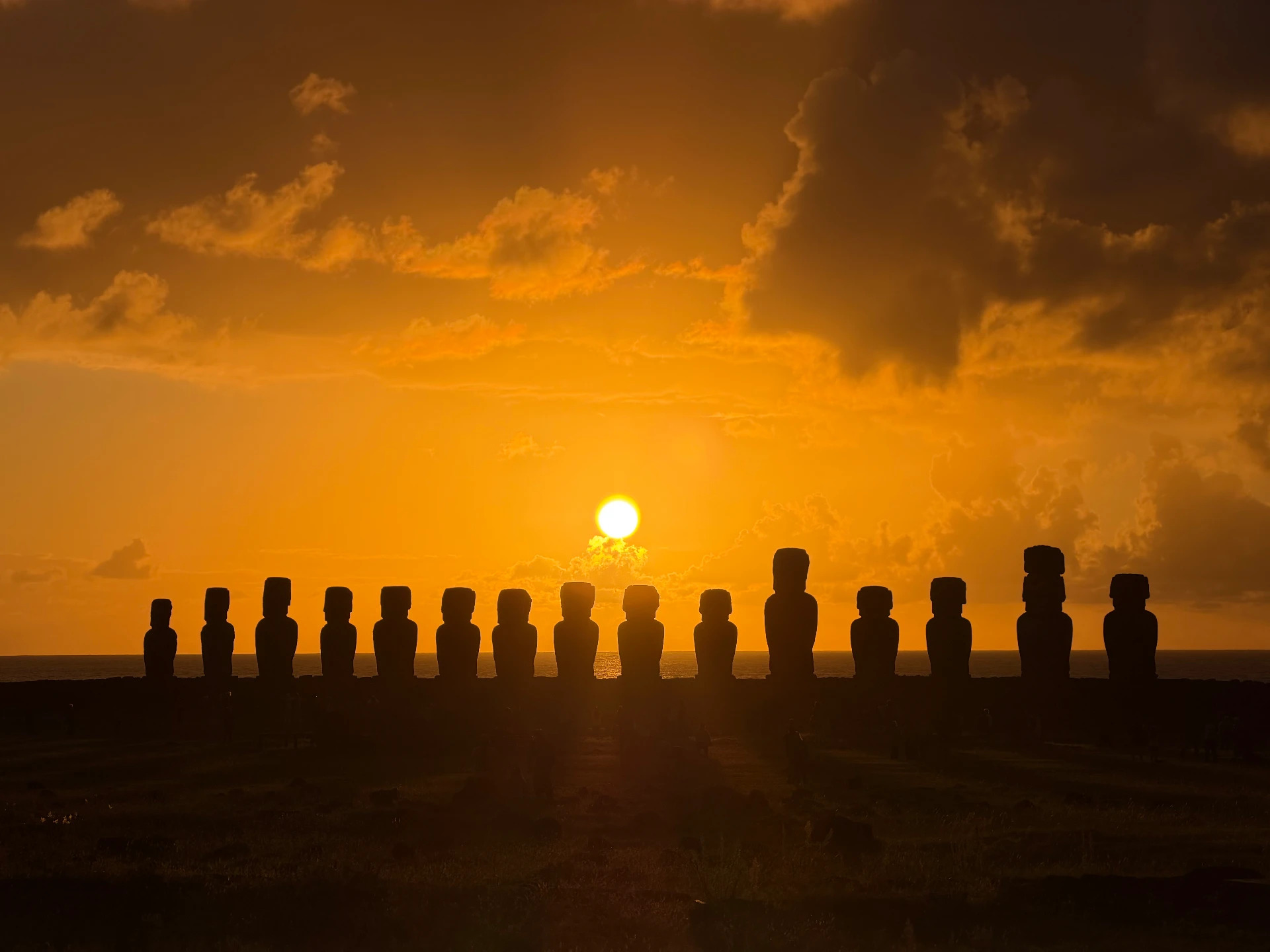 The sun rising behind the fifteen moai of Ahu Tongariki, Rapa Nui