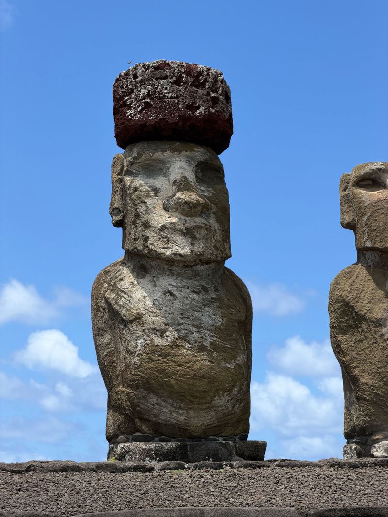 A red stone pukao atop a moai at Ahu Tongariki